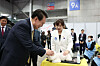 President Yoon Suk Yeol touches a poodle at the Pet Industry Association's booth at the small business convention at Kintex exhibition hall in Goyang, Gyeonggi, on Friday. [PRESIDENTIAL OFFICE]
