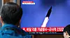 South Korean citizens watch news coverage of North Korea's ballistic missile launch at Seoul Station in Yongsan District, central Seoul, on Tuesday. [YONHAP]