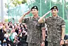 Members RM, left, and V of boy band BTS salute to fans after finishing their military duties on June 10 in Gangwon. [NEWS1]