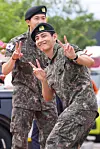 Members RM and V of boy band BTS post for photos in joy after finishing their military duties on June 10 in Gangwon. [YONHAP]