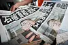 A staff member distributes an extra edition of the Yomiuri Shimbun newspaper, with headline reading ″Prime Minister Ishiba towards resignation,″ Wednesday, July 23, 2025, in Tokyo. {AP/YONHAP]