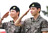 Members RM, left, and V of boy band BTS salute to fans after finishing their military duties on June 10 in Gangwon. [YONHAP]