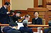 Members of the National Assembly's impeachment investigation committee talk among themselves at the Constitutional Court on Feb. 18. [JOINT PRESS CORPS]