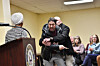 A man is tackled after spraying an unknown substance at U.S. Representative Ilhan Omar, left, during a town hall she was hosting in Minneapolis, Minnesota, on Jan. 27. [AFP/YONHAP]