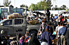 A Taliban security personnel stands on the back of a vehicle as Afghan refugees arrive at the zero point of the Islam Qala border crossing between Afghanistan and Iran on June 28, following their deportation from Iran. [AFP/YONHAP]