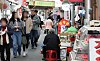 Shoppers walk past vendors at a traditional market in Jongno District, central Seoul, on April 15. The Korean government announced a supplementary budget aimed at addressing urgent national priorities including small business support on April 18. [NEWS]