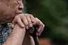 An older man leans on his cane. [GETTY IMAGES BANK]