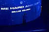 A fan takes a picture in front of the visual screen at Théatre des Lumières. [SPOTIFY]