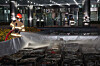 A firefighter sprays water on scorched lithium-ion batteries submerged in a fire suppression tank at the National Information Resources Service in Yuseong District, Daejeon, on the night of Sept. 27. [YONHAP]