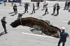 First responders and police officials control and examine the site where a sinkhole appeared in Yeonhui-dong, western Seoul, on Aug. 29. [NEWS1]