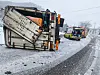 A truck lies on its side after sliding on an icy road in South Jeolla on Feb. 6. [YONHAP]