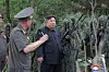 North Korean leader Kim Jong-un, center, speaks to officials during his visit to a special operations training base on Aug. 27. [KOREAN CENTRAL NEWS AGENCY]
