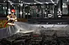 A firefighter cools down burnt batteries at the National Information Resources Service (NIRS) in Daejeon on Sept. 27. [YONHAP]