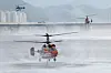 Helicopters from the Korea Forest Service and fire authorities collect water from the nearby Geumho River on May 1 to fight the rekindled wildfire on Mount Hamji in Buk District, Daegu, after it was brought under control on April 29. [YONHAP]