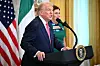 U.S. President Donald Trump speaks alongside Mary O'Shea, right, wife of unseen Irish Prime Minister Micheal Martin, as they participate in a St. Patrick's Day Reception in the East Room of the White House in Washington, DC, on March 12. [AFP/YONHAP]