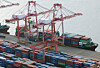 Containers for exports and imports are piled at a pier in the southeastern port city of Busan on Jan. 1, 2024.  [YONHAP]