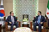 South Korean Foreign Minister Cho Tae-yul, left, and his Syrian counterpart Asaad al-Shaibani, right, converse before formally signing the documents for a diplomatic relationship agreement between the two countries in Damascus on April 10. [MINISTRY OF FOREIGN AFFAIRS]