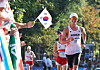 A fan waves a Korean flag as Choe Byeong-kwang competes in the men's 20-kilometer race walk at the Paris Olympics Thursday. [YONHAP]