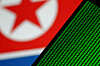 Binary code is seen on a screen against a North Korean flag in this illustration on Nov. 1, 2017. [REUTERS/YONHAP]