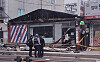 Police stand outside a building in Uijeongbu, Gyeonggi, where a sign that fell onto the pavement crushed a passing man on Jan. 10. [YONHAP]