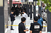 Police officials are seen in front of Shinsegae Department Store's main branch in Jung District, central Seoul on Aug. 5, after an online threat to blow up the store was posted the same day. [YONHAP]