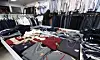 A staff member organizes school uniforms at a secondhand uniform store in Songpa District, southern Seoul, on Feb. 19. [NEWS1]