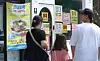 Pedestrians walk by a street in Gyeongsan, North Gyeongsang, on July 27, with an advertisement showing a notice that customers can use consumer coupons at a nearby restaurant. [YONHAP]