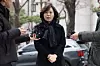 Kim Kyung, a Seoul city council member facing pay-to-play allegations with her nomination, answers reporters’ questions as she arrives at the Seoul Metropolitan Police Agency’s Public Crime Investigation Unit in Mapo District, western Seoul, for police questioning as a suspect. [YONHAP]