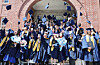International students throw their graduation caps at their graduation ceremony at Donga University, Busan. The number of international students currently enrolled in universities or language schools in Korea has surpassed 270,000 for the first time. [YONHAP]
