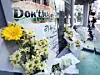 Flowers commemorating late Lee Young-chul are placed in front of his burger shop on Dec. 14. [NEWS1]