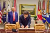 Korean President Lee Jae Myung signs a guestbook at the White House in Washington on Aug. 25 as U.S. President Donald Trump looks on. [JOINT PRESS CORPS]