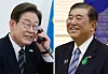 President Lee Jae-myung, left, holds a phone in his office at the presidential office building in Yongsan District, central Seoul, as he speaks with Japanese Prime Minister Shigeru Ishiba on June 9. [JOONGANG ILBO]