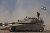 An Israeli soldier stands on the top of a tank parked on an area near the Israeli-Gaza border, as seen from southern Israel on Aug. 20. [AP/YONHAP]