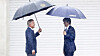 Former President Moon Jae-in, left, greets Cho Kuk, the leader of the liberal Rebuilding Korea Party, in front of his residence in Pyeongsan Village in Yangsan, South Gyeongsang, on Monday. [NEWS1]