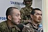 Chinese nationals Zhang Renbo, left, and Wang Guangjung, right, look on during a press conference in Kyiv on April 14. Zhang and Wang were captured by Ukrainian forces in the Donetsk region during what they claimed to be their first combat mission on the frontline. [AFP/YONHAP]