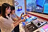 Customers test sunscreen products at a department store in Korea in June. [LOTTE DEPARTMENT STORE]