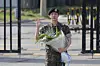BTS's Jin, with a bouquet in his hand, waves at dozens of cameras as he gets discharged from the ROK Army 5th Infantry Division Recruit Training Center in Yeoncheon County, Gyeonggi, on June 12, 2024, after completing 18 months of mandatory military service. [YONHAP]