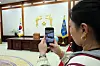 A visitor takes a photo of former presidential workspace at Blue House in Jongno District, central Seoul on April 9. After impeached President Yoon Suk Yeol relocated the presidential office to Yongsan District, Blue House has been opened to the public. [NEWS1]