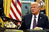 U.S. President Donald Trump signs executive orders in the Oval Office of the White House in Washington on Jan. 20. [AP/YONHAP]