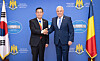 Defense Minister Shin Won-sik, left, and his Romanian counterpart, Angel Tilvar, shake hands during their meeting in Romania on Wednesday. [YONHAP]
