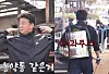 Paik Jong-won, right, and one of his employees are seen using a pesticide sprayer to apply apple juice to meat, in a video uploaded on Paik's YouTube channel on Nov. 20, 2023. [SCREEN CAPTURE]