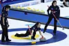 Korea's Kim Su-ji, center, releases the stone during an LGT World Women's Curling Championship match against Canada at Uijeongbu Indoor Ice Rink in Uijeongbu, Gyeonggi on March 19. [YONHAP]
