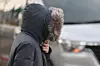 A citizen in Gwanghwamun, central Seoul, holds their coat close on the morning of Nov. 17 when temperatures suddenly dropped compared to the previous day. [YONHAP]