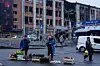 People sell food at the market in front of a building, damaged by a Russian strike, in Kyiv, Ukraine, on Dec. 1. [AP/YONHAP]