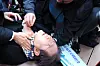 Democratic Party leader Lee Jae-myung lies on the ground after being stabbed in his neck during a visit to observe the new airport site on Gadeok Island, Busan, on Jan. 2. [YONHAP]