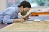 A conservator is restoring a traditional painting and calligraphic work at the National Museum of Korea's new Conservation Science Center in Yongsan District, central Seoul, on Oct. 28. [NEWS1]