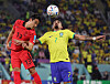 Korea's Son Jun-ho, left, vies for the ball with Brazil's Lucas Paqueta during a 2022 World Cup round of 16 match at Stadium 974 in Doha, Qatar on Dec. 6, 2022. [YONHAP]