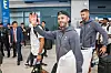 James Maddison, center, waves his right hand as he leaves the airport, holding a pillow with his left arm. [COUPANG PLAY]