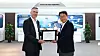 Nick Wells, the vice president of Jaguar Land Rover Automotive's Procurement for China Asia Pacific Region, left, presents Park Jeong-ho, the head of Samsung SDI’s Tianjin subsidiary, the certification for the JLR Quality Award during a ceremony on April 23. [SAMSUNG SDI]