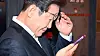 Democratic Party leader Lee Jae-myung looks at his phone after his meeting with workers at Jongno District, central Seoul, on May 1. [JOONGANG ILBO]
